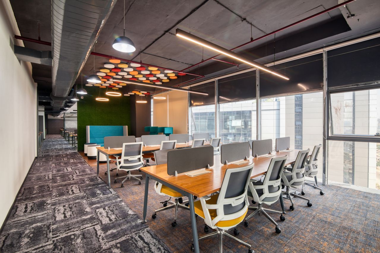 services-01 Spacious and modern open office interior with desks and chairs, ideal for business environments.