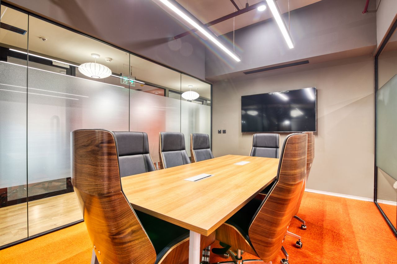 team-02 Sophisticated conference room with sleek furniture and glass walls. Ideal for business meetings.