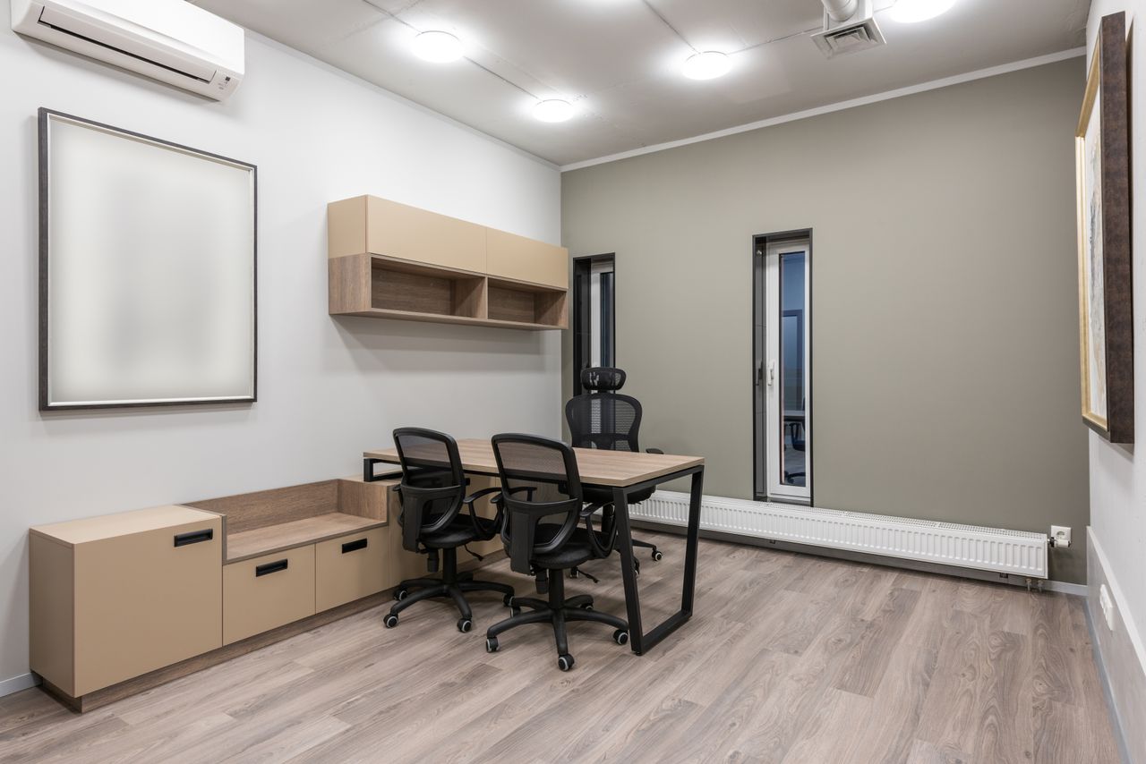 team-01 Spacious modern office with minimalist design featuring neutral tones and sleek furniture.